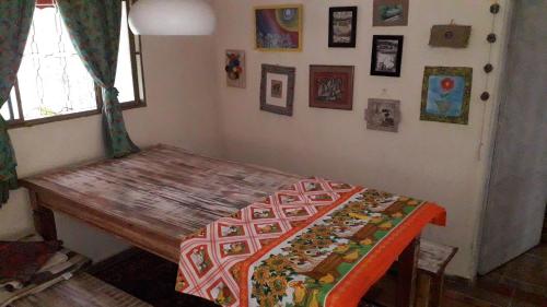 a room with a wooden table and a window and a table sidx sidx at Sitio Aguá Santa in Itapeva