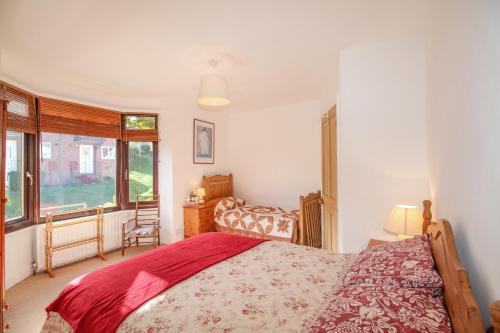 a bedroom with a large bed and a window at Bay View in Swanage