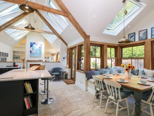 a kitchen and living room with a table and chairs at Bailey Cottage in Southampton