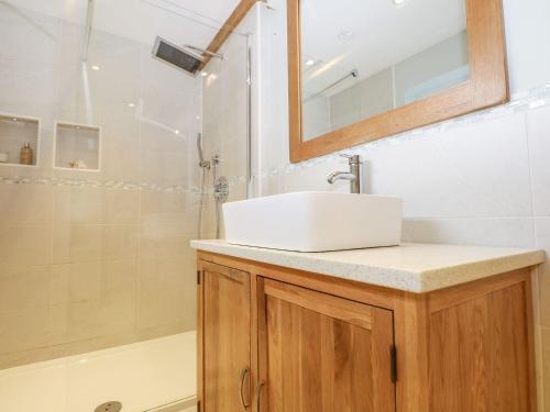 a bathroom with a sink and a shower at Bailey Cottage in Southampton