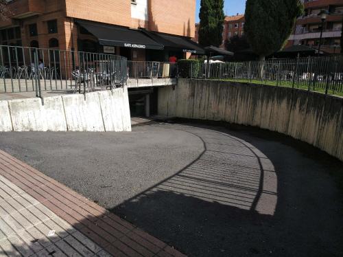 a bridge over a street with a sidewalk and a building at Andramari Tourist Home Parking& wifi in Amorebieta-Etxano
