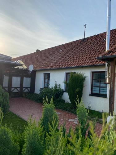 a white house with a brown roof at GoldStar Apartments nähe Messe in Sarstedt