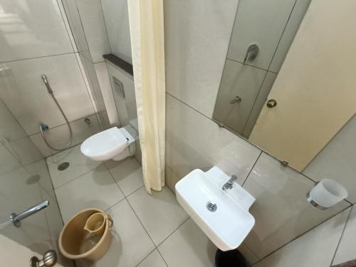 a bathroom with a sink and a toilet and a shower at Sri Aswin Grand in Nāmakkal