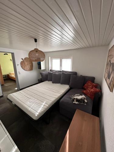 a living room with a couch and a ceiling at Appartement Maasai Mara mit Whirlpool und Sauna in Bad Saulgau