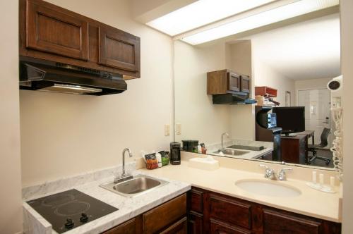 uma cozinha com dois lavatórios e uma bancada em Baymont by Wyndham Tuscaloosa em Tuscaloosa