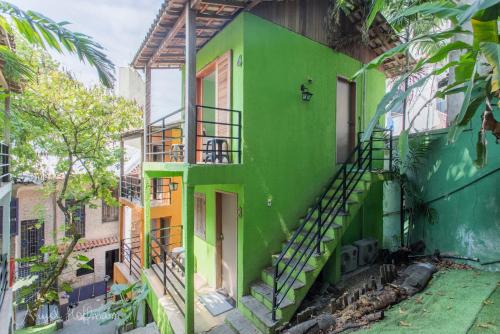 a green building with stairs on the side of it at Pura Vida Hostel in Rio de Janeiro