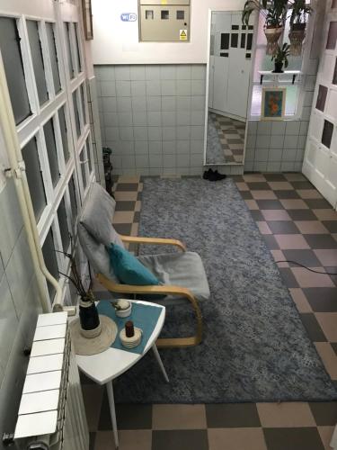 a bathroom with a blue tile floor and a black and white checkered at Prenociste Chardak in Tuzla