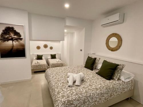 een slaapkamer met een bed en een spiegel aan de muur bij Apartamentos El Olivo in Córdoba