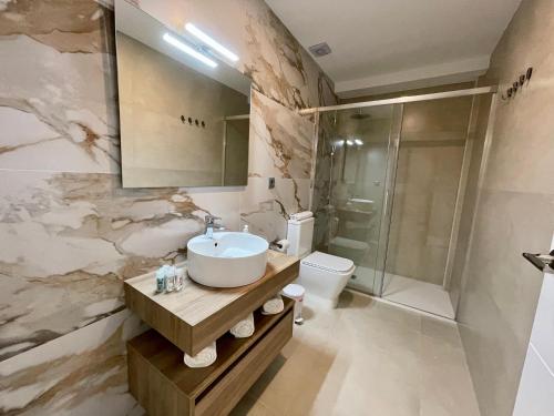 a bathroom with a sink and a shower and a toilet at Apartamentos El Olivo in Córdoba