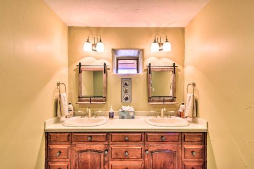 a bathroom with two sinks and two mirrors at Luxe Twin Lakes House with Mountain and Lake Views! in Twin Lakes