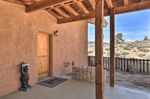 a porch of a house with a wooden door at Luxe Twin Lakes House with Mountain and Lake Views! in Twin Lakes