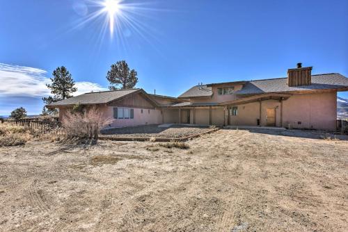 a house in the middle of a field at Luxe Twin Lakes House with Mountain and Lake Views! in Twin Lakes