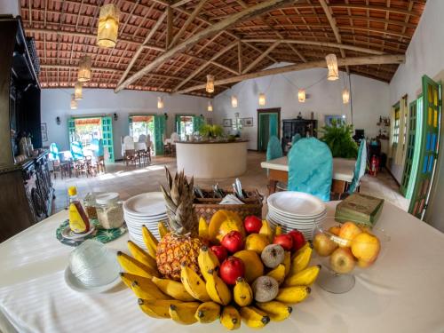 a table with a bowl of fruit on it at Hotel Marina Porto Abrolhos in Caravellas