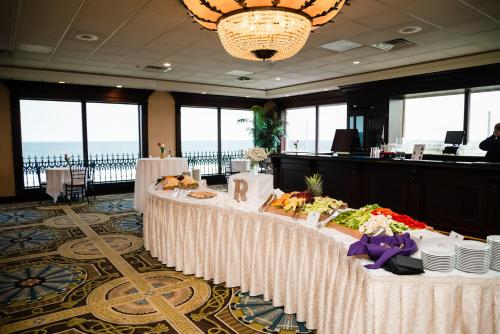 a table with food on it in a room with windows at Grand Hotel Cape May in Cape May
