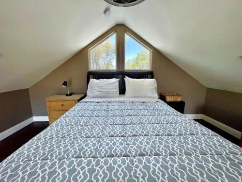 1 dormitorio con 1 cama grande y ventana grande en Cheerful one bedroom loft cabin close to wineries, en Fair Play