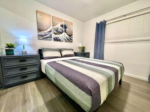 a bedroom with a bed and a painting on the wall at Quiet Remodeled 3 Bedroom in Heart of Downtown Sacramento in Sacramento