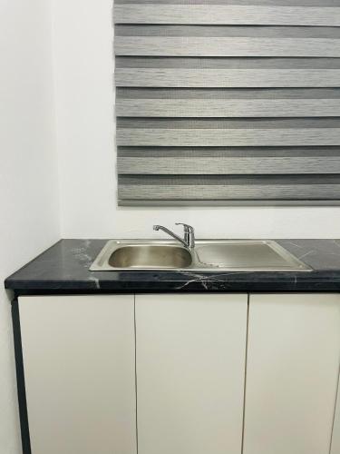 a kitchen counter with a sink and a window at Moh Ville Guest House in Maseru