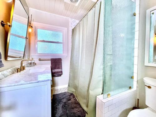 a bathroom with a shower and a sink at Uniquely styled home minutes to Downtown Sac! in West Sacramento