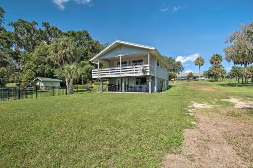 a house with a lawn in front of it at Riverfront Apt with Kayak Launch in Dunnellon in Dunnellon
