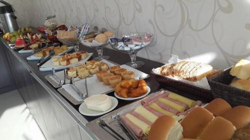 a buffet with many different types of food on a table at Premium Palace Hotel in Ariquemes
