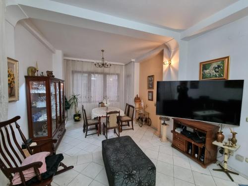 a living room with a large flat screen tv at Tsar Simeon, 2 bedroom, living room and fireplace in Sofia
