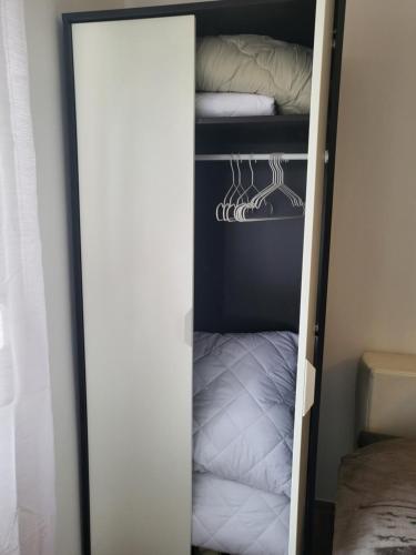 a walk in closet with a mirror next to a bed at Studio 12 in Zagreb