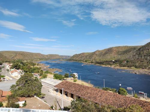 a view of a river with mountains in the background at Pousada Maria Bonita - Piranhas, Alagoas. in Piranhas