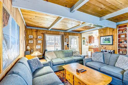 a living room with blue couches and a table at Foxglove Terrace in South Lake Tahoe