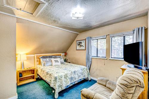 a bedroom with a bed and a tv and a couch at Foxglove Terrace in South Lake Tahoe