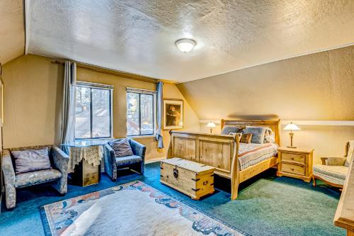 a bedroom with a bed and a chair and a table at Foxglove Terrace in South Lake Tahoe