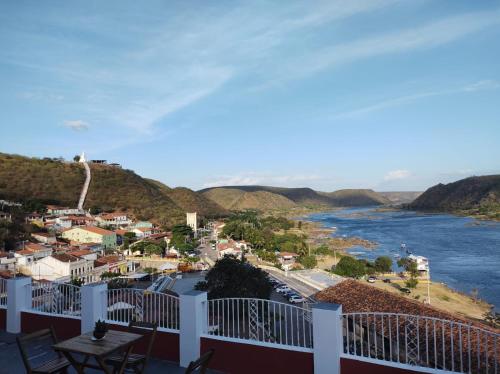 a view from a balcony of a town and a river at Pousada Maria Bonita - Piranhas, Alagoas. in Piranhas