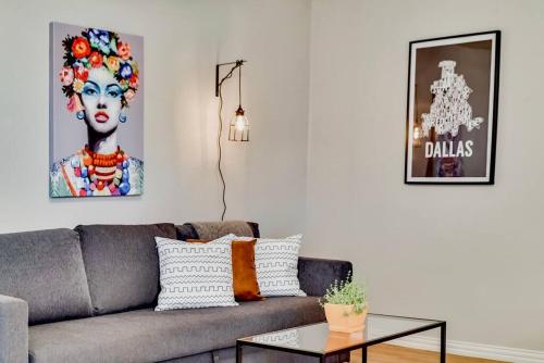 a living room with a gray couch and a table at Global Cup Dallas Boutique Flat - Arboretum Tickets Included in Dallas