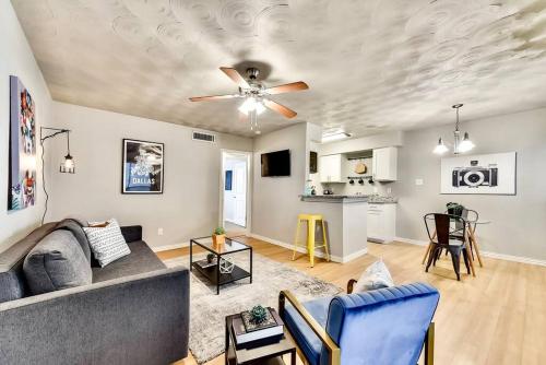 a living room with a couch and a ceiling fan at Global Cup Dallas Boutique Flat - Arboretum Tickets Included in Dallas