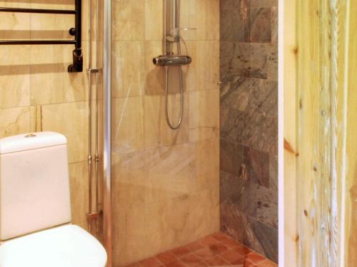 a bathroom with a shower with a toilet at Holiday home MORA III in Börka