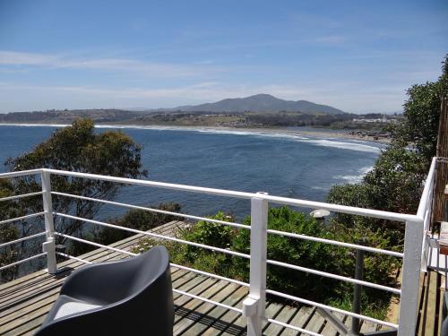 a balcony with a chair and a view of a beach at Laura del Mar Hotel Boutique in Concón
