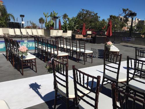 a row of tables and chairs next to a pool at Crowne Plaza Hotel Los Angeles Harbor, an IHG Hotel in San Pedro