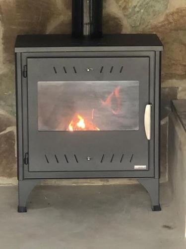 a stove with a fire inside of it at Spitaki in Ioannina