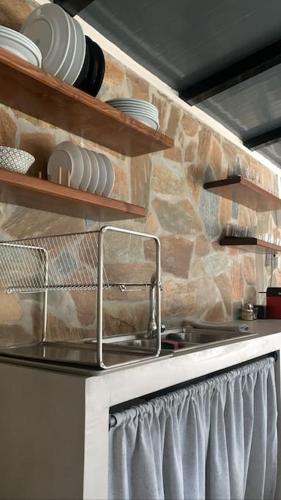 a kitchen with a sink and a stone wall at Spitaki in Ioannina