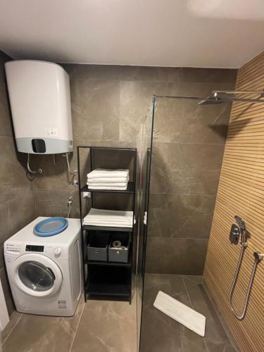 a bathroom with a washing machine and a washer at Residence 33 in Sarajevo