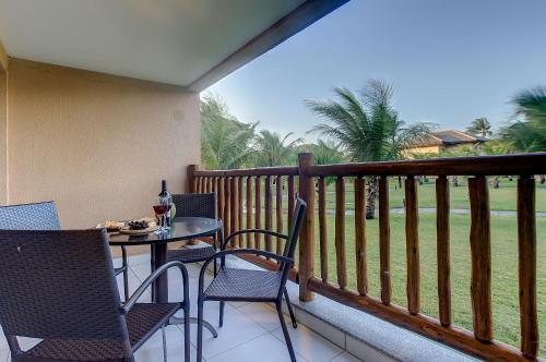 a patio with a table and chairs on a balcony at VG Sun #102 - Apto de Dois Quartos por Carpediem in Paracumbuca
