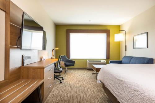 a hotel room with a bed and a desk at Holiday Inn Express & Suites - San Jose Silicon Valley by IHG in San Jose