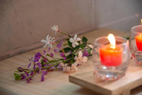 a table with two candles and flowers on it at Casa Cielo en Chena Magica in Maipú