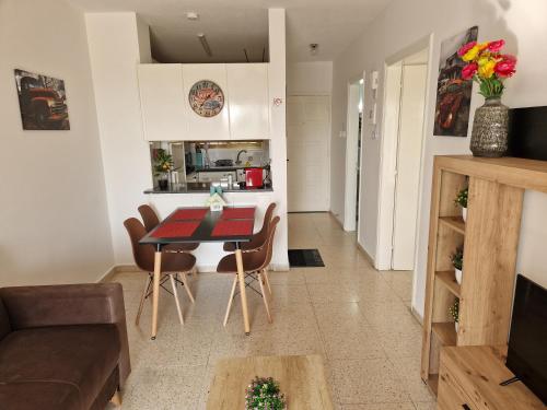a living room and kitchen with a table and chairs at La Veranda Sea View apartments in Larnaca