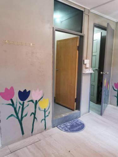 a room with a door with flowers painted on the wall at Dreamcatcher Homestay, Kundasang in Ranau