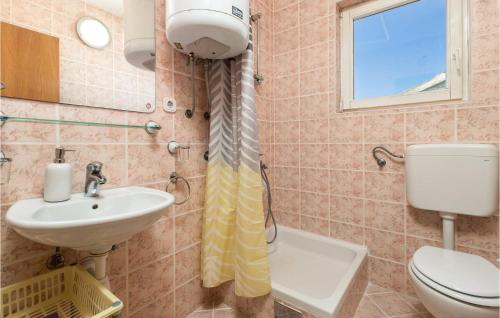 a bathroom with a toilet and a sink at Lovely Apartment In Stara Novalja With House Sea View in Stara Novalja