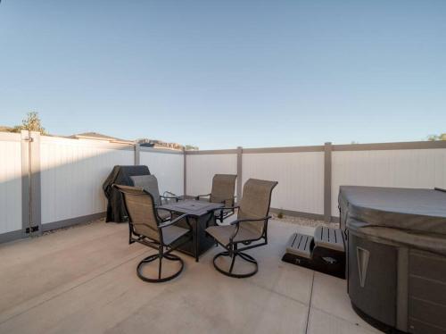 a patio with chairs and a table on a roof at Majestic Zion Cottage with hot tub in Hildale in Hildale