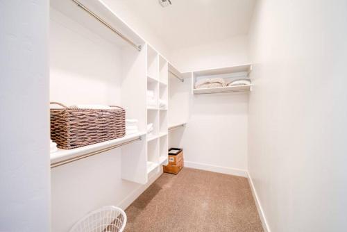 a walk in closet with white walls and white shelves at Majestic Zion Cottage with hot tub in Hildale in Hildale