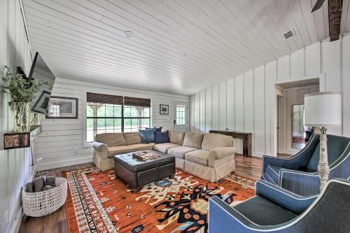a living room with a couch and a table at Modern Kilgore Home with Yard about 14 Mi to Lake! in Kilgore