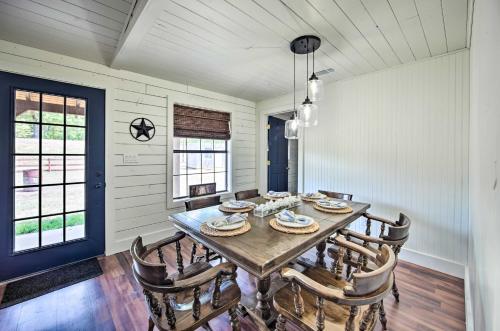 a dining room with a wooden table and chairs at Modern Kilgore Home with Yard about 14 Mi to Lake! in Kilgore