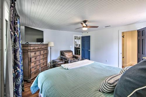 a bedroom with a bed with a television and a chair at Modern Kilgore Home with Yard about 14 Mi to Lake! in Kilgore